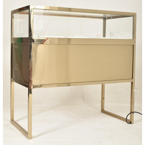 269 - A contemporary high end design gilt metal & glass bijouterie display cabinet table. The cabinet ... 