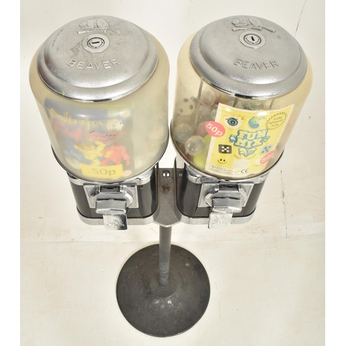 291 - Beaver - two vintage 20p coin operated black sweet shop candy vending machines on stand. Each confec... 