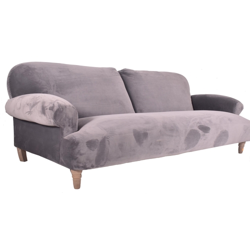 295 - A large contemporary designer four seater sofa settee. The sofa having a scrolled back and armrests ... 