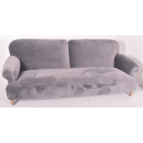 295 - A large contemporary designer four seater sofa settee. The sofa having a scrolled back and armrests ... 