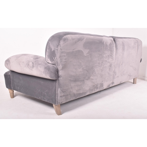 295 - A large contemporary designer four seater sofa settee. The sofa having a scrolled back and armrests ... 