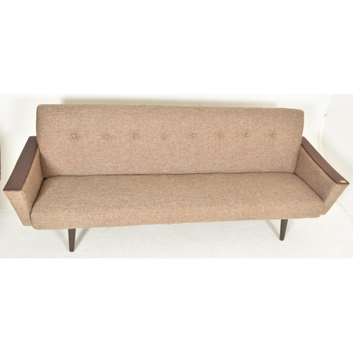 336 - A vintage Danish mid century teak and buttonback upholstered long sofa / settee. The sofa of squared... 