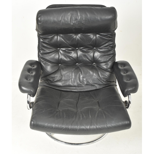 355 - Ekornes - a Swedish Modern Design 20th century 1970s chrome framed and black leather swivel lounge a... 