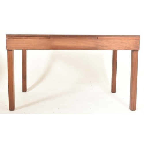 364 - Remploy, Britain - a retro mid 20th century teak dining table with four chairs. The table having a s... 