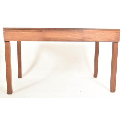 364 - Remploy, Britain - a retro mid 20th century teak dining table with four chairs. The table having a s... 