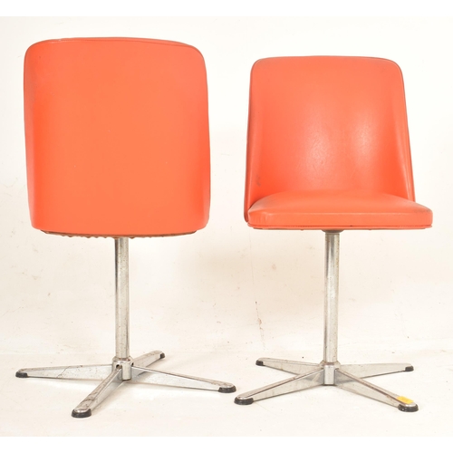 381 - A pair of retro late 20th century orange leatherette swivel office chairs. Each having a curved back... 