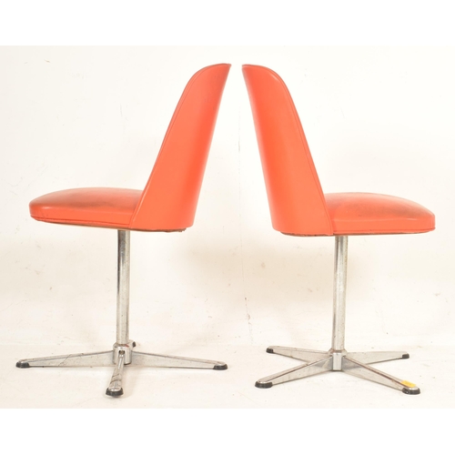 381 - A pair of retro late 20th century orange leatherette swivel office chairs. Each having a curved back... 