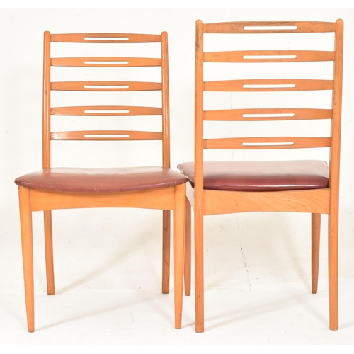 432 - A set of four retro mid 20th century Danish inspired teak framed dining chairs in the manner of Neil... 