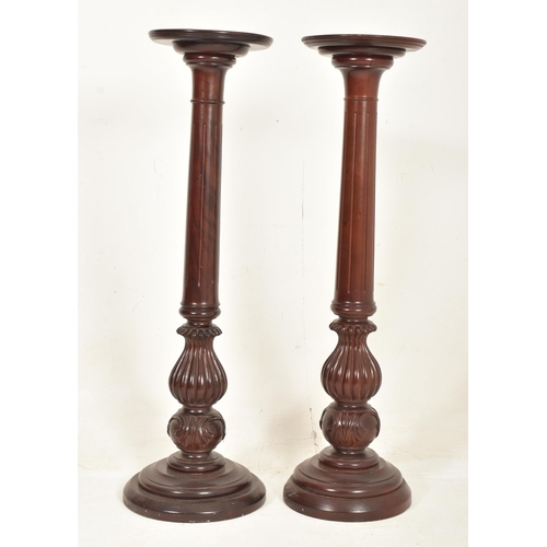 438 - A collection of five contemporary high end design carved wood floor torchere column stands of variou... 