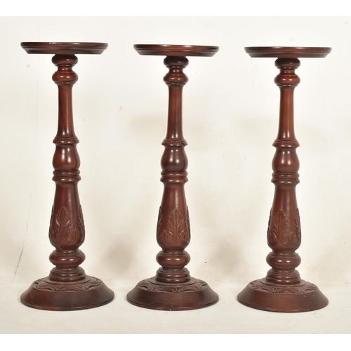 438 - A collection of five contemporary high end design carved wood floor torchere column stands of variou... 