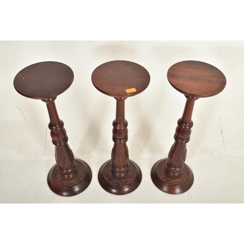 438 - A collection of five contemporary high end design carved wood floor torchere column stands of variou... 