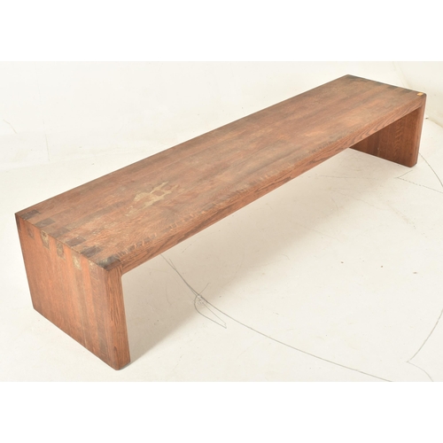 441 - A contemporary high end design solid oak jointed low bench seat. The bench of rectangular form with ... 