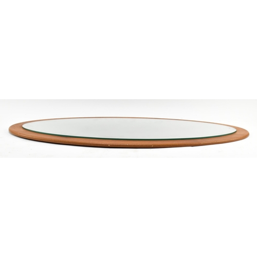 449 - A vintage mid century 1960s oval shaped teak framed mirror. The mirror of extended oval shaped form.... 