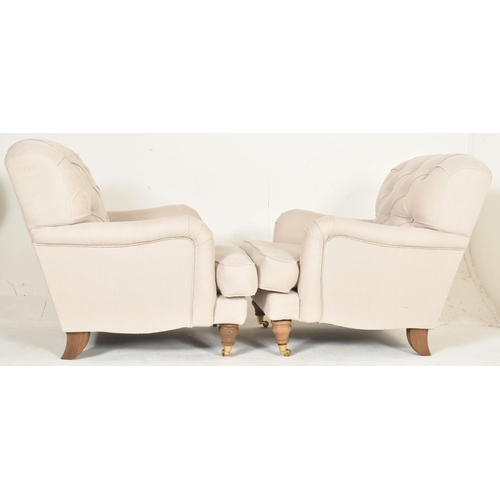 460 - A matching pair of high-end British modern design armchairs. Each chair having button-backed backres... 