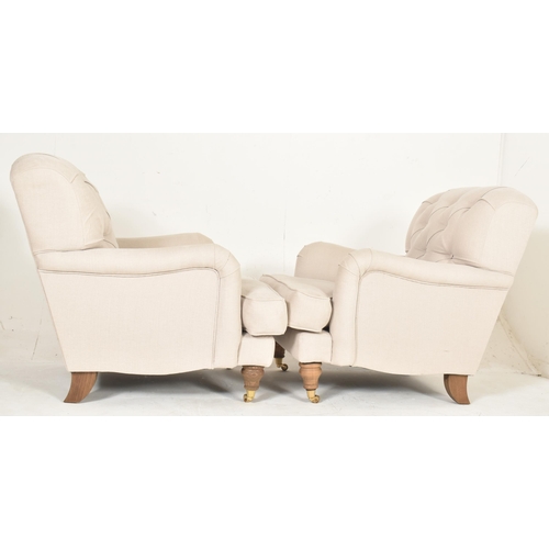 460 - A matching pair of high-end British modern design armchairs. Each chair having button-backed backres... 