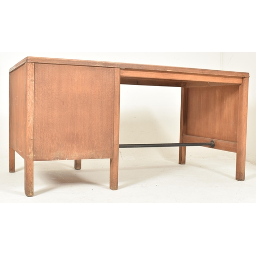 481 - A retro 20th century pine wood & leather top office writing desk tbale. The desk having a rectan... 