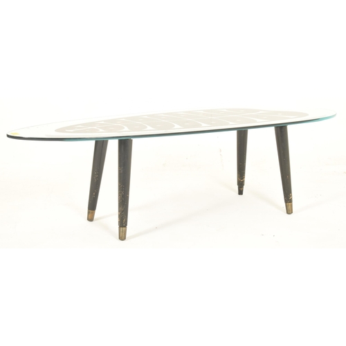 514 - An Italian retro mid 20th century glass & ebonised wood occasional shaped coffee table. The low ... 