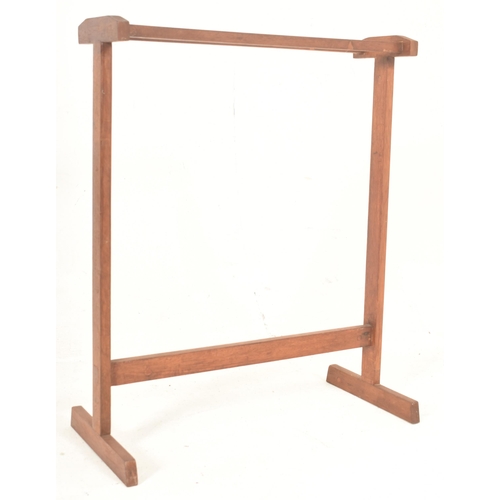 528 - A retro mid 20th century teak wood towel / clothes rack stand. The rak having two top supports, rais... 