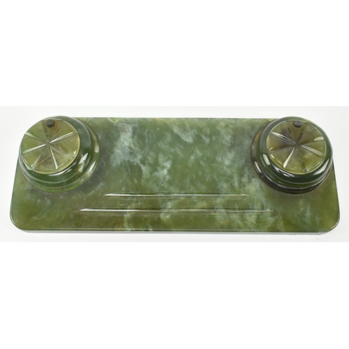 53 - An Art Deco early 20th century circa 1930s green onyx desk tidy featuring inkwells. The desk tidy of... 