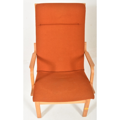 532 - Finn Ostergaard - a vintage mid century 1970s oak and orange upholstered armchair. The armchair with... 