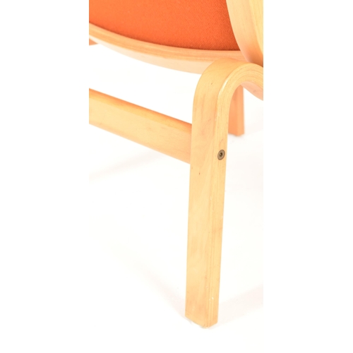 532 - Finn Ostergaard - a vintage mid century 1970s oak and orange upholstered armchair. The armchair with... 