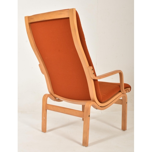 532 - Finn Ostergaard - a vintage mid century 1970s oak and orange upholstered armchair. The armchair with... 