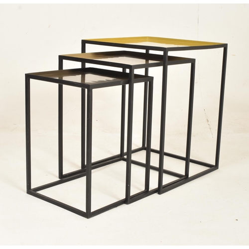 552 - A set of British Modern Design metal nesting tables. The nest of three tables of square form with ye... 