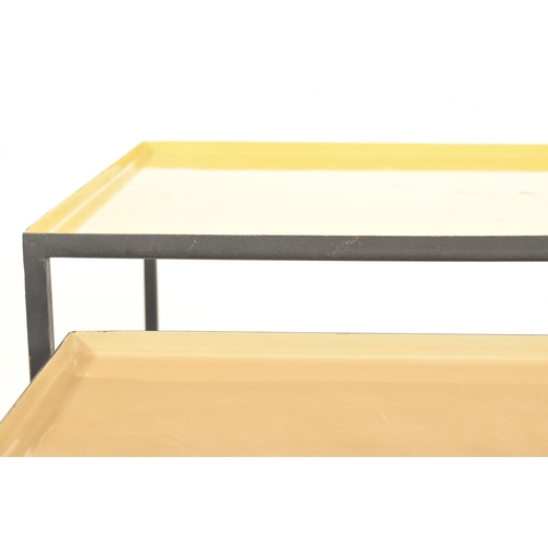 552 - A set of British Modern Design metal nesting tables. The nest of three tables of square form with ye... 