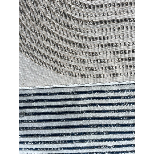 566 - 'Think Rugs' - a Modern Designer floor carpet rug. The rug having a grey ground with patterned blue ... 