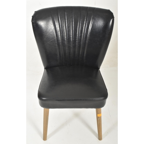 567 - A British Modern Design 20th century sky black leather & wooden cocktail lounge easy chair. The ... 