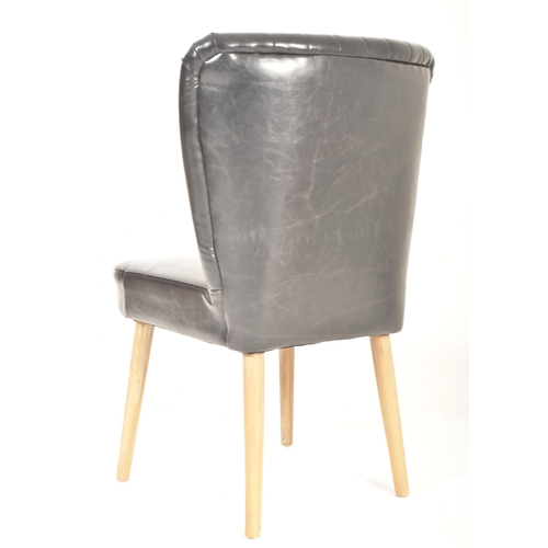 567 - A British Modern Design 20th century sky black leather & wooden cocktail lounge easy chair. The ... 