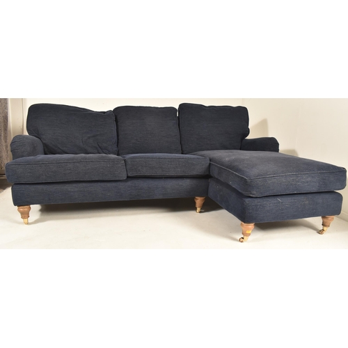 580 - A British Modern Design L-shaped three-seater sofa settee and matching ottoman / footrest. The sofa ... 