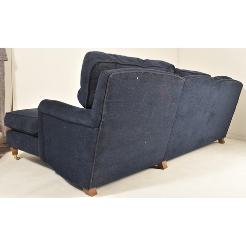 580 - A British Modern Design L-shaped three-seater sofa settee and matching ottoman / footrest. The sofa ... 