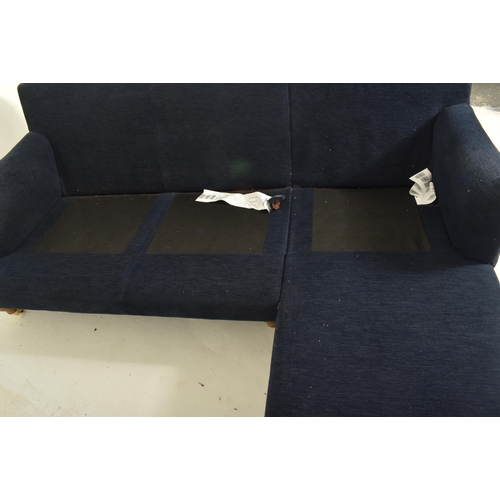 580 - A British Modern Design L-shaped three-seater sofa settee and matching ottoman / footrest. The sofa ... 