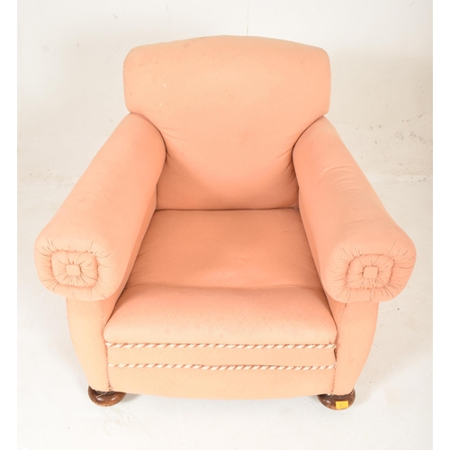 582 - An early 20th century club armchair. The chair having a padded backrest and cushioned seat with thic... 