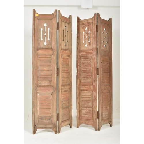 586 - A two-part / fourfold 20th century hardwood shutters / room divider screen. Upright form with panele... 