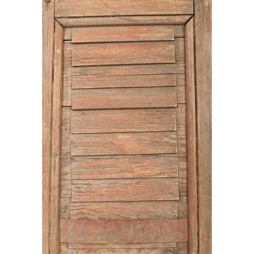 586 - A two-part / fourfold 20th century hardwood shutters / room divider screen. Upright form with panele... 