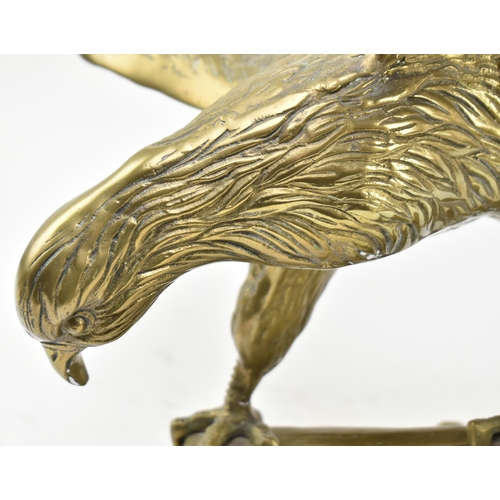 596 - A vintage early 20th century large table top eagle sculpture. The bird sculpture figured standing on... 