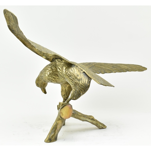 596 - A vintage early 20th century large table top eagle sculpture. The bird sculpture figured standing on... 