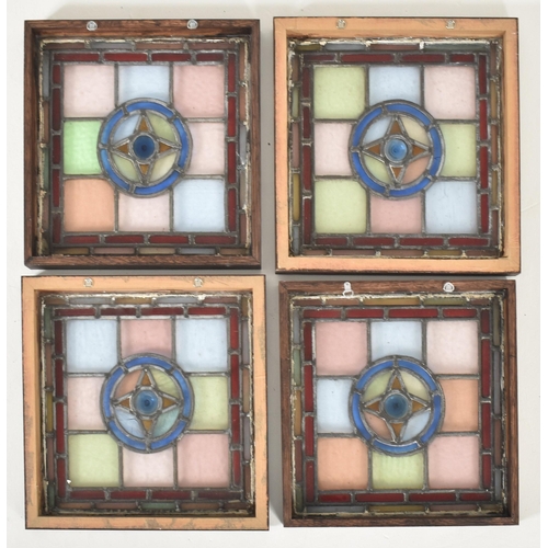 598 - Four vintage mid century decorative stained glass windows. The window panels each featuring geometri... 