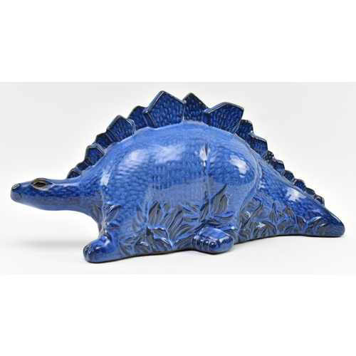 61 - A vintage blue ceramic studio pottery figurine of a Stegosaurus dinosaur. The figure hollow, with bl... 