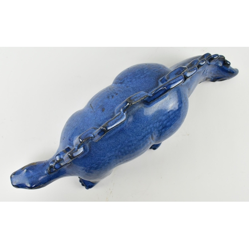 61 - A vintage blue ceramic studio pottery figurine of a Stegosaurus dinosaur. The figure hollow, with bl... 