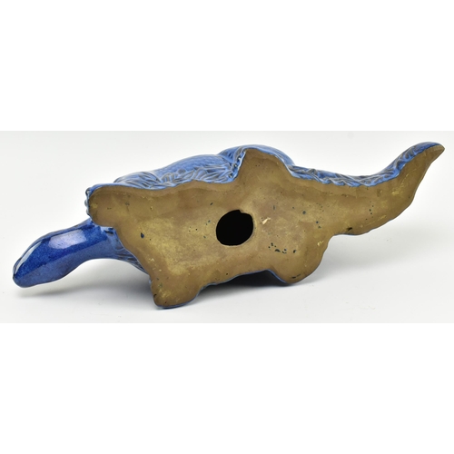 61 - A vintage blue ceramic studio pottery figurine of a Stegosaurus dinosaur. The figure hollow, with bl... 