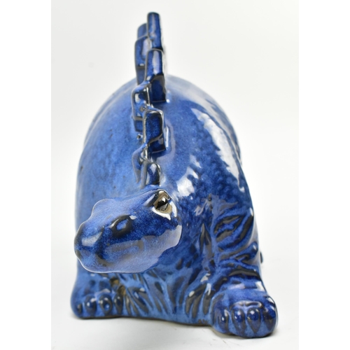 61 - A vintage blue ceramic studio pottery figurine of a Stegosaurus dinosaur. The figure hollow, with bl... 