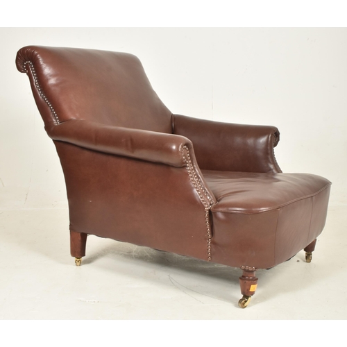 64 - A 20th century Art Deco influenced club armchair / library chair. The chair having scrolled arms and... 