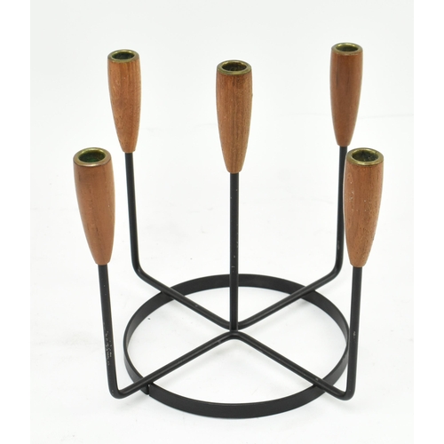 92 - A retro 20th century Danish design candlestick holder. The candlestick having five turned teak holde... 