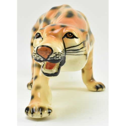 96 - A vintage 20th century hand painted fine bone china figure of leopard. The cat in walking position w... 