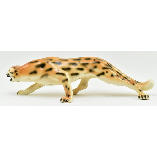 96 - A vintage 20th century hand painted fine bone china figure of leopard. The cat in walking position w... 