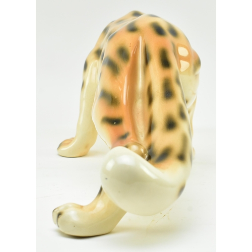 96 - A vintage 20th century hand painted fine bone china figure of leopard. The cat in walking position w... 