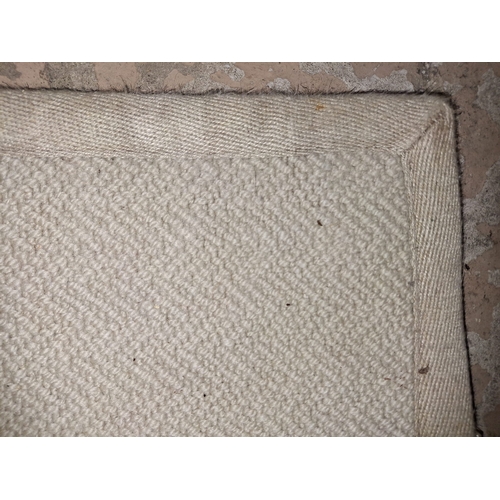 397 - A large contemporary high end design cream colourway floor carpet rug. Of rectangular form with wove... 